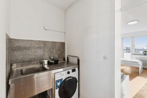 a kitchen with a sink and a washing machine at Apartment mit Balkon in Lünen in Lünen
