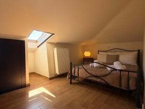 a bedroom with a bed and a skylight at VASILICA Apartments in Ierissos