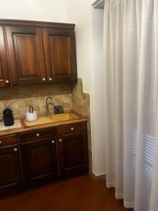 a kitchen with a sink and a shower curtain at Valle degli Ulivi appartamento in Terni +40 photos