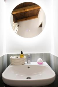 a bathroom with a white sink with a mirror at Luce sul Duomo in Tivoli +26 photos