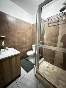 a bathroom with a toilet and a sink and a shower at Casa Privé, Comayagua in Comayagua