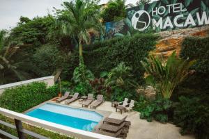a resort with a pool and chairs and a hotel masaya at Hotel Macaw Cúcuta in Cúcuta