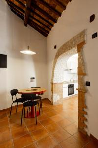 a kitchen with a table and chairs in a room at Luce sul Duomo in Tivoli