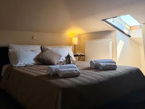a bedroom with a bed with two towels on it at VASILICA Apartments in Ierissos
