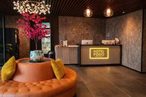 a lobby with a sign and a chair in a room at Hotel Fogo Amsterdam in Amsterdam
