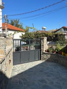 a gate to a house with a stone wall at Vila Du Lac Blue in Lin