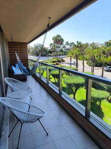 a balcony with hammocks and a view of a park at Salgados Beach&Golf - Praia dos Salgados in Albufeira