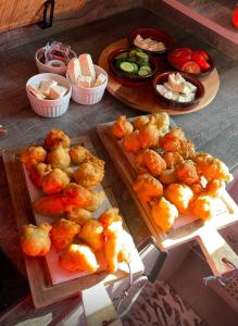 a table topped with plates of food and appetizers at Vila Du Lac Blue in Lin