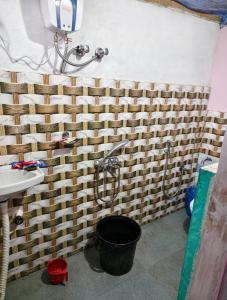 a bathroom with a shower and a bucket at Green Haven in Kalimpong
