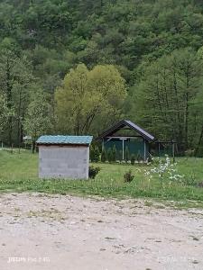 a small building in a field with a gazebo at Kamp Suad in Zaglavica