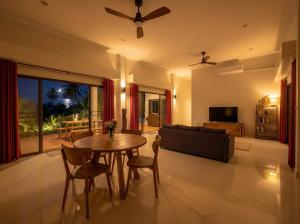 a living room with a table and a couch at Ayeda Villa 2 in Krabi