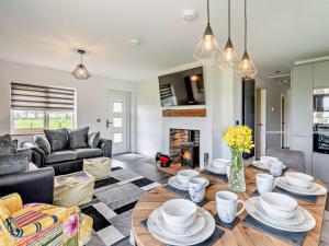 a living room with a table and a fireplace at 3 Bed in Carlisle oc-94673 in Longtown