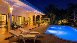 a house with a swimming pool at night at Ayeda Villa 2 in Krabi