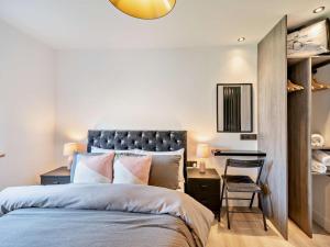 a bedroom with a bed and a desk with a chair at 3 Bed in Carlisle oc-94673 in Longtown