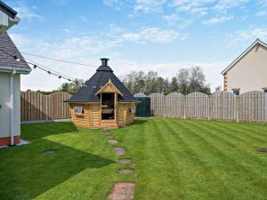 a small dog house in a yard next to a fence at 3 Bed in Carlisle oc-94673 in Longtown
