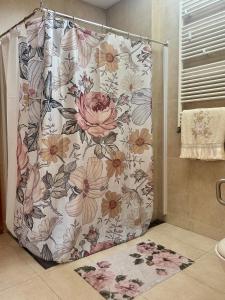 a shower curtain with a floral pattern in a bathroom at Vintage Boutique Room in Lavra +17 photos