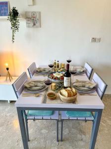 a table with a bunch of food and wine at Latchi Premium View in Lachi