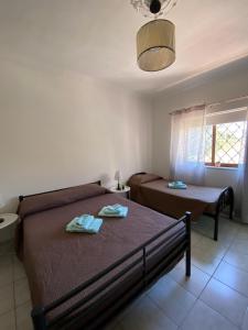 a bedroom with two beds and a window at St Julians Mansion Rooms in St. Julianʼs