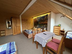 a room with a table and chairs and a bedroom at ANTON Tenczyn in Tenczyn