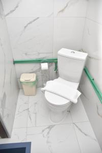 a white bathroom with a toilet and a trash can at Villa Boris in Junčev Do +26 photos