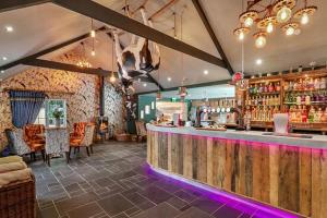 a bar in a restaurant with a counter and chairs at Little Green Glamping Pod in Narberth