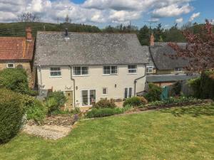 an aerial view of a house with a yard at 4 Bed in Bridport oc-dc195 in Loders