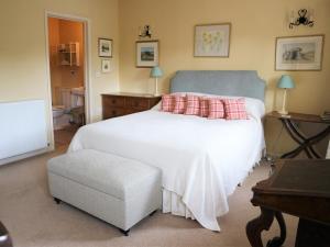 a bedroom with a white bed with a blue headboard at 4 Bed in Bridport oc-dc195 in Loders