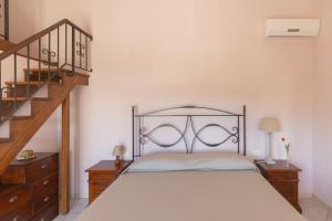 a bedroom with a bed with a wrought iron headboard at Appartamenti Bellavista by ElbaSummer in Portoferraio