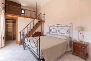 a bedroom with a bed and a staircase at Appartamenti Bellavista by ElbaSummer in Portoferraio