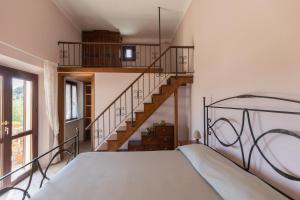 a bedroom with a bed and a staircase at Appartamenti Bellavista by ElbaSummer in Portoferraio +74 photos