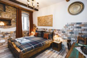 a bedroom with a bed in a room with brick walls at AQUILA D'ORO TRIESTE in Trieste