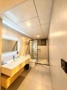 a bathroom with a sink and a toilet at NAIYI Forest Park Resort in Zhangjiajie +88 photos