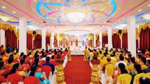 a crowd of people sitting in a room with a ceremony at achi gest house in Mulliyavalai