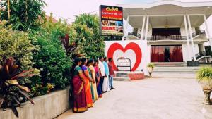 a group of women standing in front of a building at achi gest house in Mulliyavalai