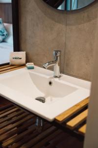 a bathroom sink in front of a mirror at Hotel Macaw Cúcuta in Cúcuta +50 photos