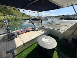 a boat with a wooden deck with a table on it at Vedette location à la nuitée sur l eau in Valence
