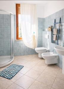 a bathroom with a shower and a toilet and a sink at L'isola felice in Cecina +23 photos