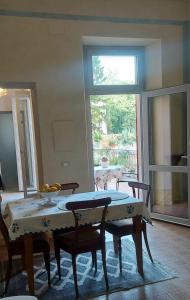 a dining room with a table and chairs and a window at Millenovecento in Cremona +10 photos