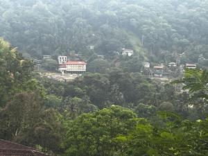 a view of a mountain with houses and trees at Long Villa in Kandy