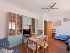 a living room with a table and a tv at Domus Caelestia in Anzio