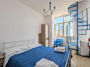 a bedroom with a blue bed and a blue ladder at Domus Caelestia in Anzio +32 photos