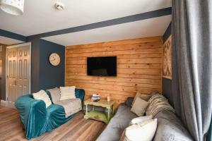a living room with a couch and a flat screen tv at 2 Private Rooms in Shared Apartment with Kitchen in Leeds