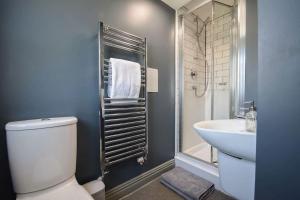 a bathroom with a toilet and a sink and a shower at 2 Private Rooms in Shared Apartment with Kitchen in Leeds