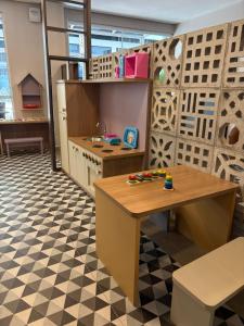 a kitchen with a table and a checkered floor at Hotel Negrini in Balneário Camboriú