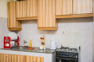 a kitchen with wooden cabinets and a counter top at lexy homes in Ruiru