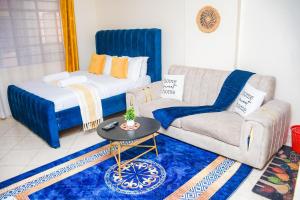 a living room with a bed and a couch at lexy homes in Ruiru