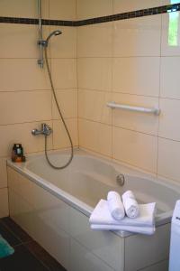 a bathroom with a bath tub with towels on it at Villa Kapitulac in Grižane +18 photos