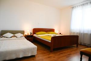a bedroom with two beds and a window at Villa Kapitulac in Grižane