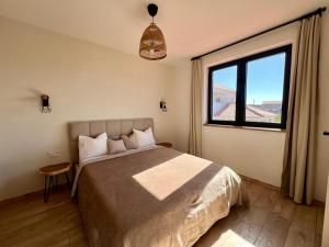 a bedroom with a bed and a large window at Vila Esnella - Private Pool & Panoramic Sea view in Primošten +23 photos