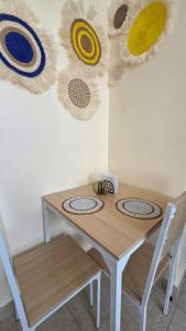 a wooden table with two chairs and some decorations on the wall at Mina Luxe Machakos in Machakos +15 photos